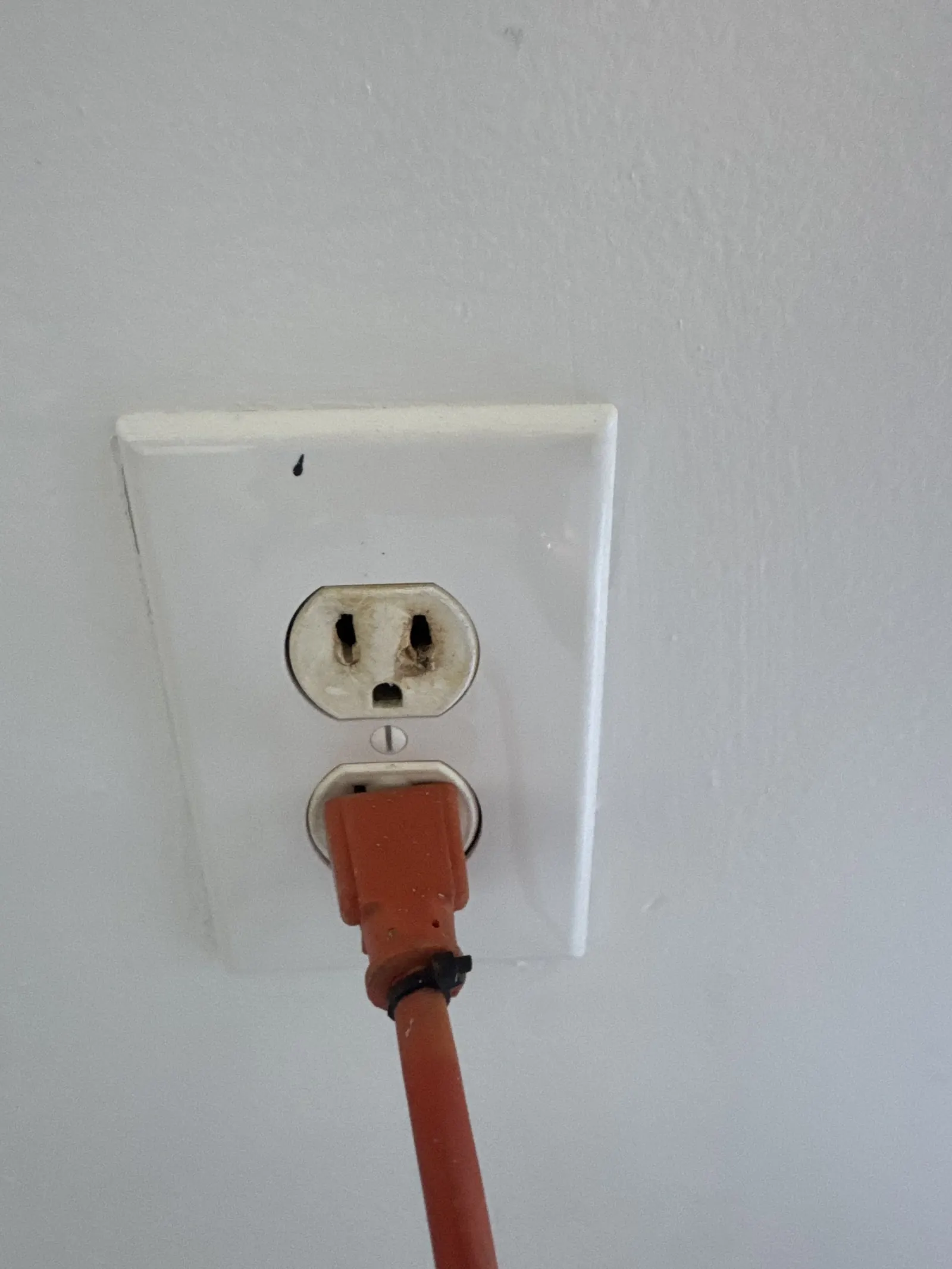 Worn outlet with a cord plugged in